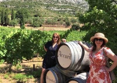Provence Wine Tours - Two friends in front of wine casks at Sainte-Victoire mountain